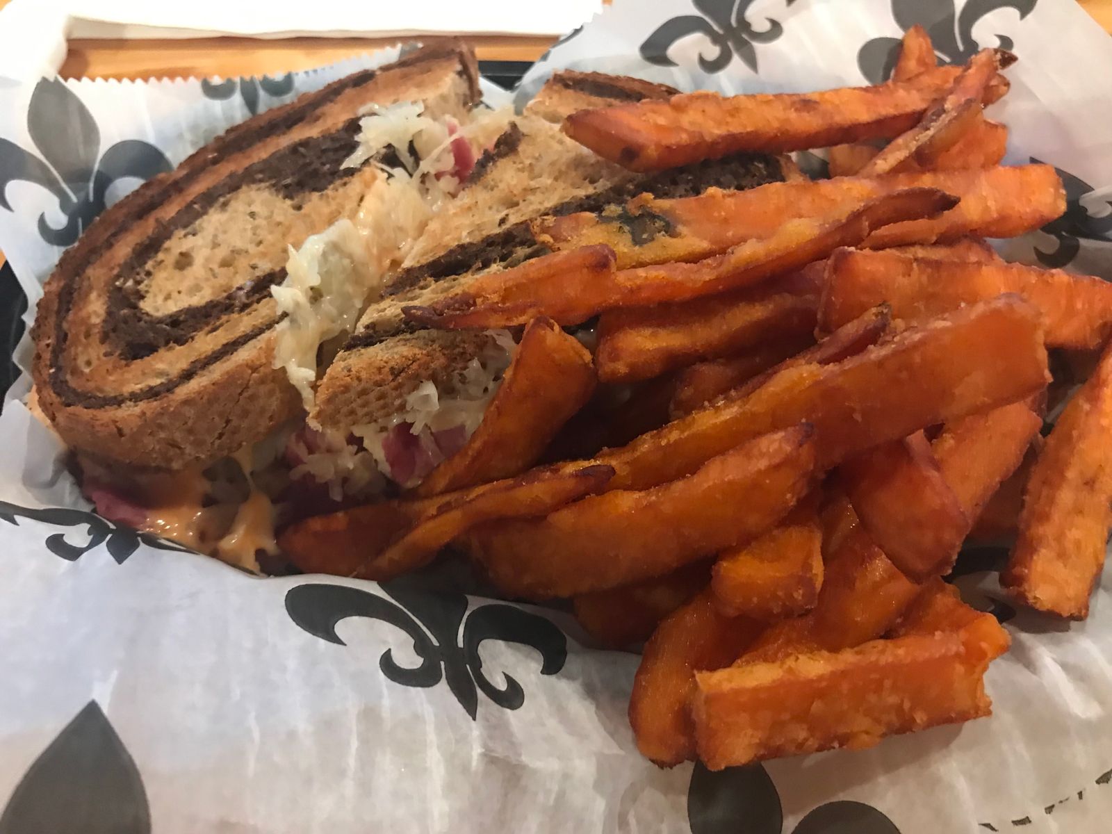 A sandwich with sweet potato fries on a table at The Galley in Morgan City.