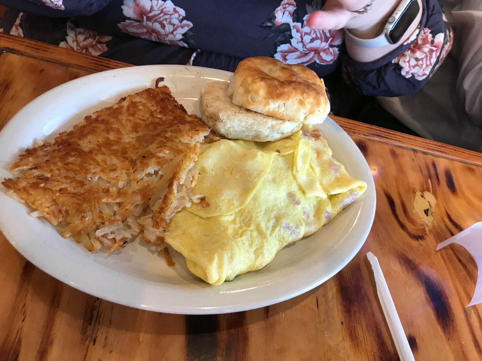 An omelet with hash browns and a biscuit on a plate at The Galley in Morgan City, Louisiana.